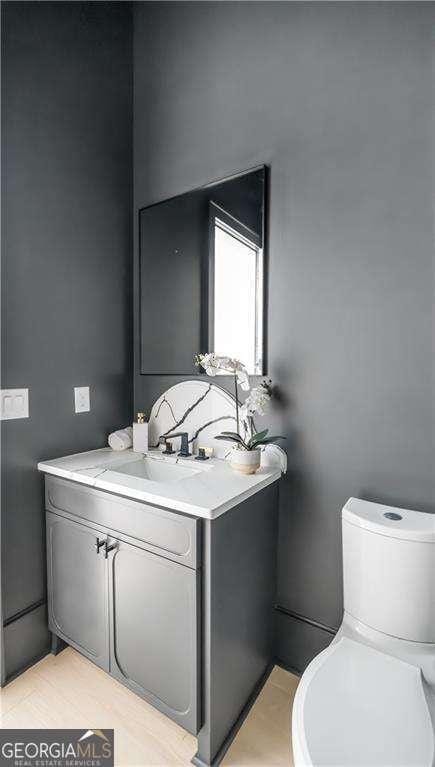 bathroom with toilet and vanity