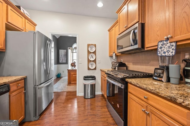 272 William Nye Dr SE, Atlanta, GA 30315 - kitchen featuring dark wood-style flooring, light stone counters, recessed lighting, decorative backsplash, and appliances with stainless steel finishes