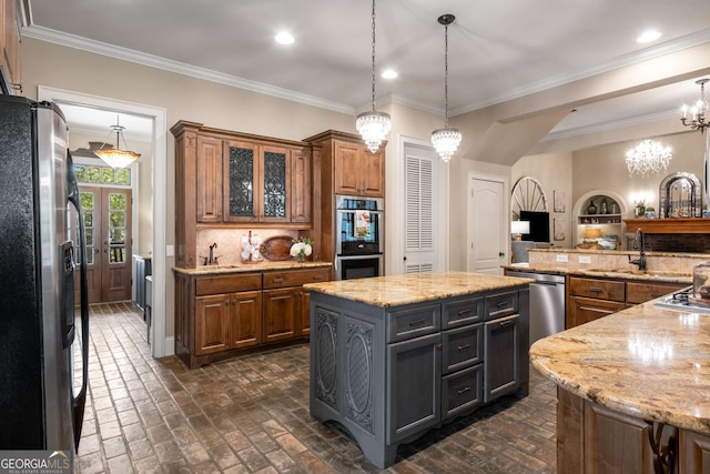 240 Trotters Rdg, Fayetteville, GA 30215 - kitchen with a chandelier, appliances with stainless steel finishes, a sink, brick floor, and brown cabinets