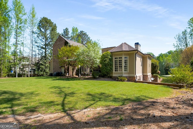240 Trotters Rdg, Fayetteville, GA 30215 - rear view of house with a chimney and a lawn