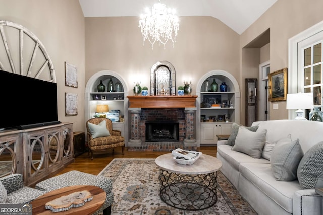 240 Trotters Rdg, Fayetteville, GA 30215 - living room featuring built in features, high vaulted ceiling, a chandelier, and wood finished floors