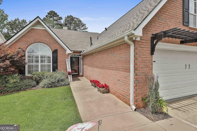 135 Fairway Ct, Newnan, GA 30265 - property entrance featuring roof with shingles, brick siding, a yard, a chimney, and an attached garage