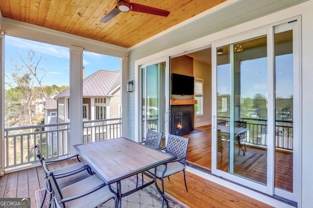 1130 Lupo Loop, Chattahoochee Hills, GA 30268 - sunroom featuring a ceiling fan, a fireplace with flush hearth, and outdoor dining area
