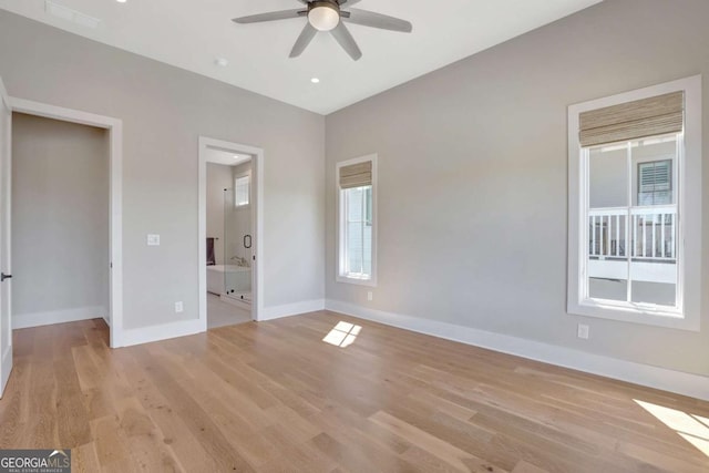 1130 Lupo Loop, Chattahoochee Hills, GA 30268 - unfurnished bedroom featuring light wood-type flooring, connected bathroom, and a ceiling fan