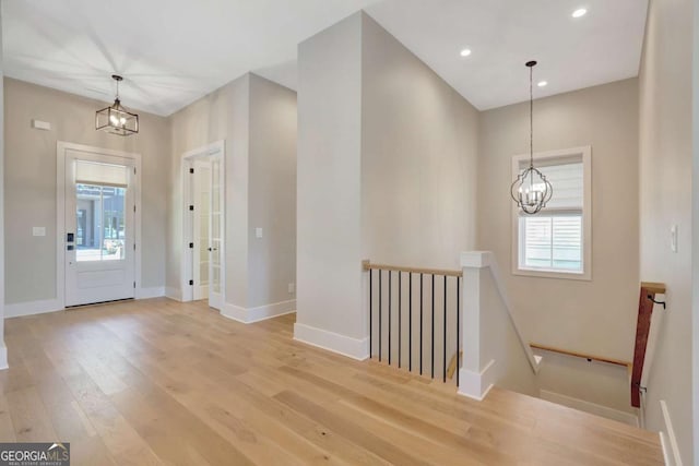 1130 Lupo Loop, Chattahoochee Hills, GA 30268 - entrance foyer with a chandelier, plenty of natural light, light wood-style flooring, and recessed lighting