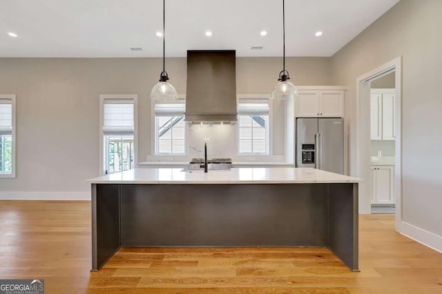 1130 Lupo Loop, Chattahoochee Hills, GA 30268 - kitchen with high end fridge, custom exhaust hood, light wood finished floors, light countertops, and recessed lighting