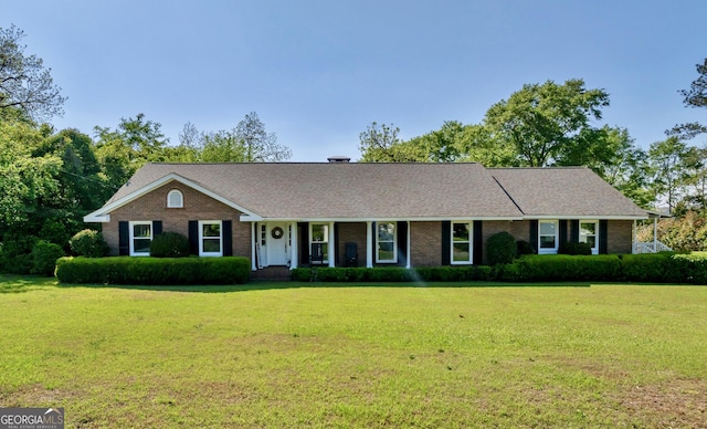 single story home featuring a front lawn and brick siding