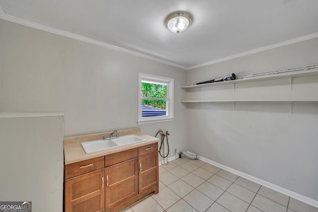 laundry room featuring light tile patterned floors, hookup for a washing machine, ornamental molding, a sink, and baseboards