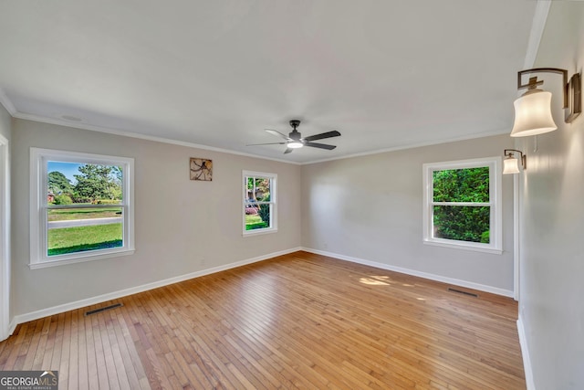 empty room featuring visible vents, baseboards, a ceiling fan, and light wood-style floors