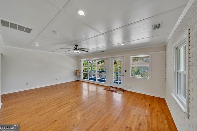 interior space with light wood-style flooring, ceiling fan, baseboards, and visible vents