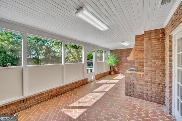 unfurnished sunroom featuring visible vents