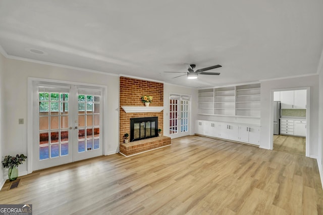 unfurnished living room featuring french doors, ornamental molding, a ceiling fan, and visible vents