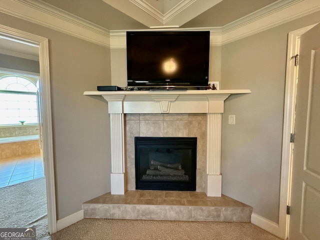 interior details with crown molding, a tiled fireplace, baseboards, and carpet