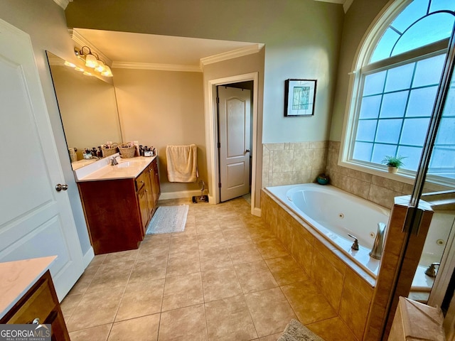 bathroom with a jetted tub, vanity, baseboards, ornamental molding, and tile patterned flooring