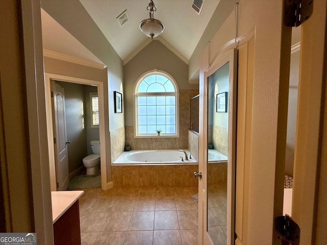 bathroom featuring visible vents, a bath, toilet, vaulted ceiling, and tile patterned flooring