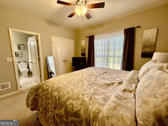 bedroom featuring visible vents, baseboards, ensuite bathroom, a ceiling fan, and carpet floors