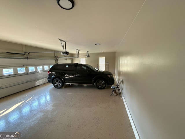garage with baseboards and a garage door opener