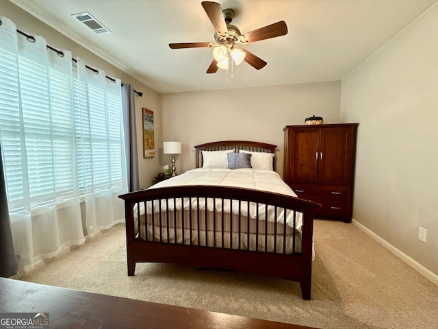 bedroom featuring light carpet, baseboards, a ceiling fan, and visible vents
