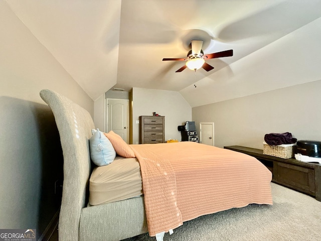 carpeted bedroom featuring ceiling fan and vaulted ceiling