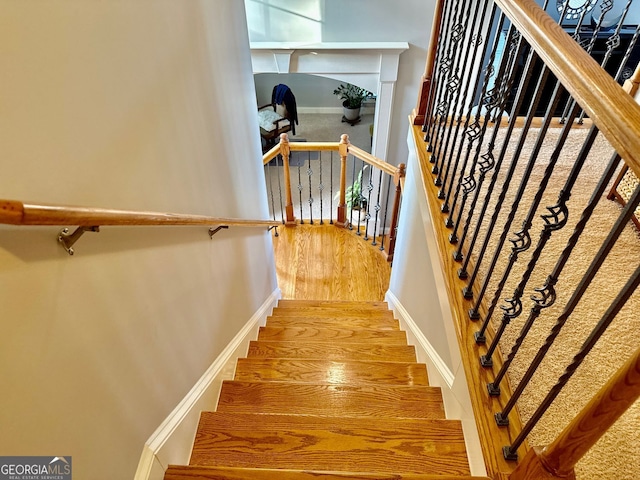 stairs featuring baseboards and wood finished floors