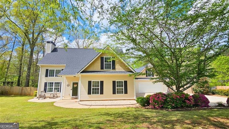 156 Brookridge, Douglasville, GA 30134 - view of front of house featuring a patio area, a front yard, fence, an attached garage, and a chimney