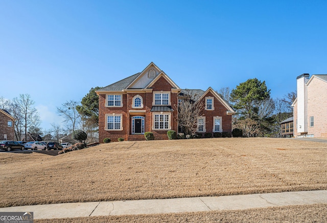 view of front facade featuring a front lawn and brick siding