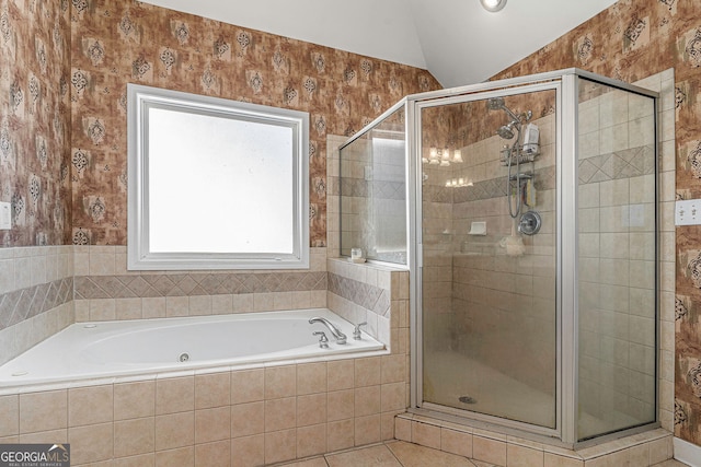 full bathroom featuring a shower stall, tile patterned floors, a garden tub, and lofted ceiling