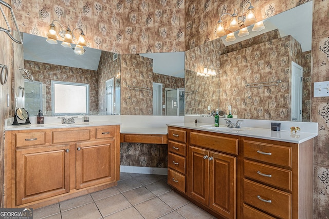 full bathroom with a shower stall, two vanities, a sink, and tile patterned flooring