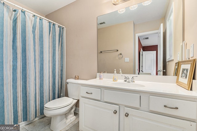 bathroom featuring toilet, visible vents, tile patterned floors, and vanity