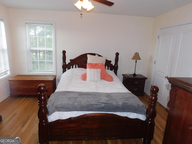 bedroom featuring baseboards, a ceiling fan, and wood finished floors