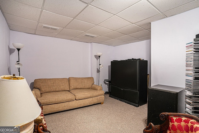 living room with carpet, visible vents, and a drop ceiling