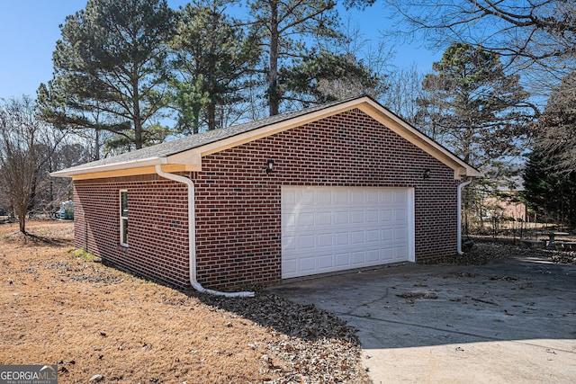 view of property exterior with a garage and brick siding
