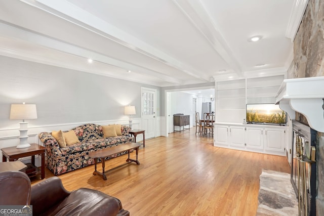 918 Guinevere Way SW, Lilburn, GA 30047 - living area featuring beamed ceiling, light wood-style floors, recessed lighting, wainscoting, and a decorative wall
