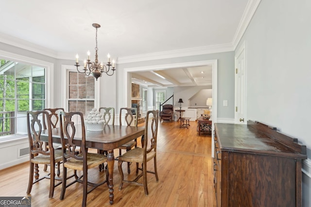 918 Guinevere Way SW, Lilburn, GA 30047 - dining room featuring a chandelier, light wood-style floors, and crown molding
