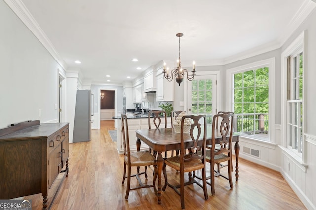 918 Guinevere Way SW, Lilburn, GA 30047 - dining area featuring a chandelier, crown molding, light wood-type flooring, and recessed lighting