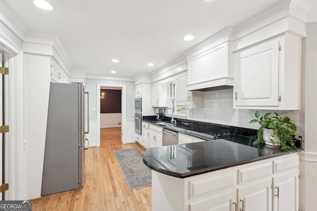 918 Guinevere Way SW, Lilburn, GA 30047 - kitchen with appliances with stainless steel finishes, crown molding, decorative backsplash, dark countertops, and white cabinets