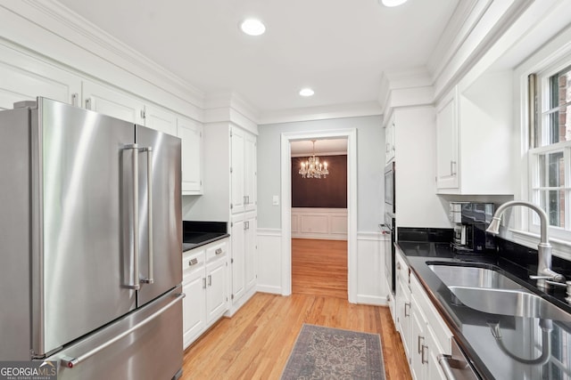 918 Guinevere Way SW, Lilburn, GA 30047 - kitchen featuring stainless steel appliances, dark countertops, a chandelier, white cabinetry, and light wood-style flooring