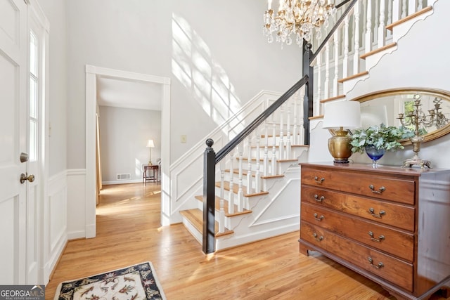 918 Guinevere Way SW, Lilburn, GA 30047 - foyer featuring stairway, light wood-style flooring, plenty of natural light, a chandelier, and ornamental molding