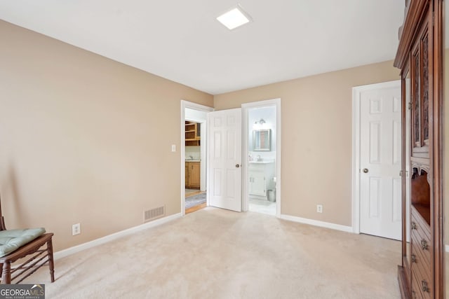 918 Guinevere Way SW, Lilburn, GA 30047 - unfurnished bedroom featuring light colored carpet and connected bathroom