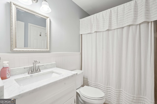 918 Guinevere Way SW, Lilburn, GA 30047 - bathroom featuring wainscoting, vanity, and a shower with curtain