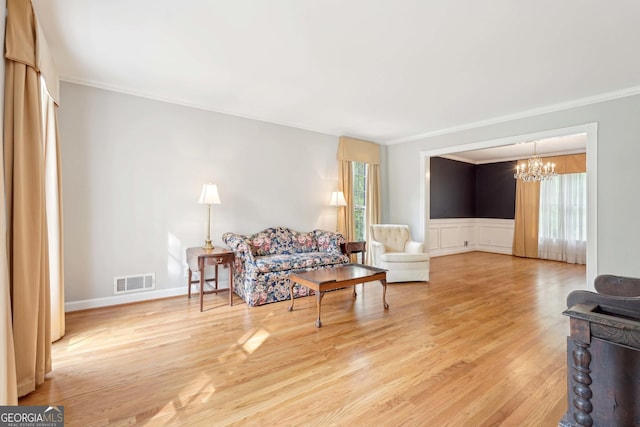918 Guinevere Way SW, Lilburn, GA 30047 - living area with a chandelier, healthy amount of natural light, crown molding, and light wood-style floors