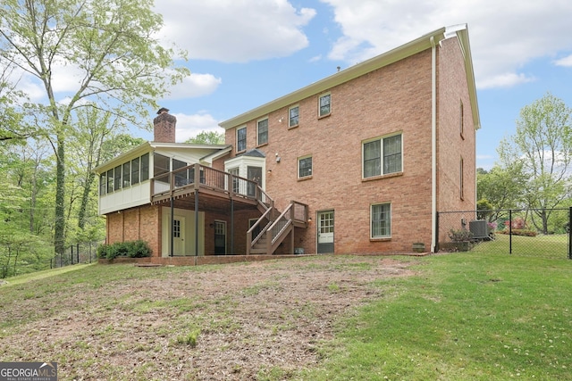 918 Guinevere Way SW, Lilburn, GA 30047 - rear view of property featuring a sunroom, a chimney, stairs, a wooden deck, and brick siding