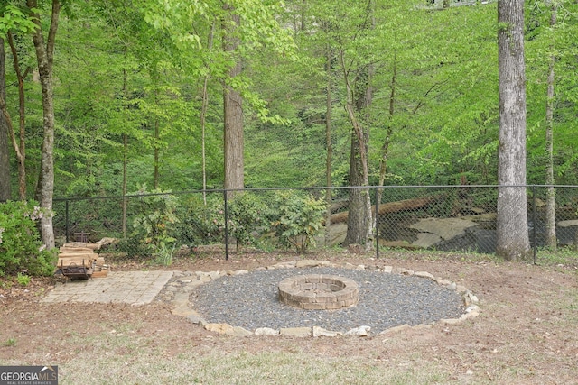 918 Guinevere Way SW, Lilburn, GA 30047 - view of yard featuring a fire pit and a wooded view
