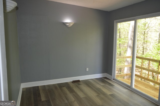 66 Topaz Ln, Royston, GA 30662 - unfurnished dining area featuring dark wood-style floors and baseboards