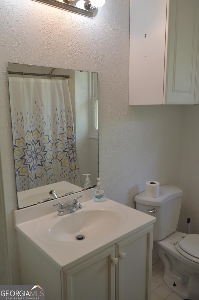 66 Topaz Ln, Royston, GA 30662 - bathroom with tile patterned floors, toilet, and vanity
