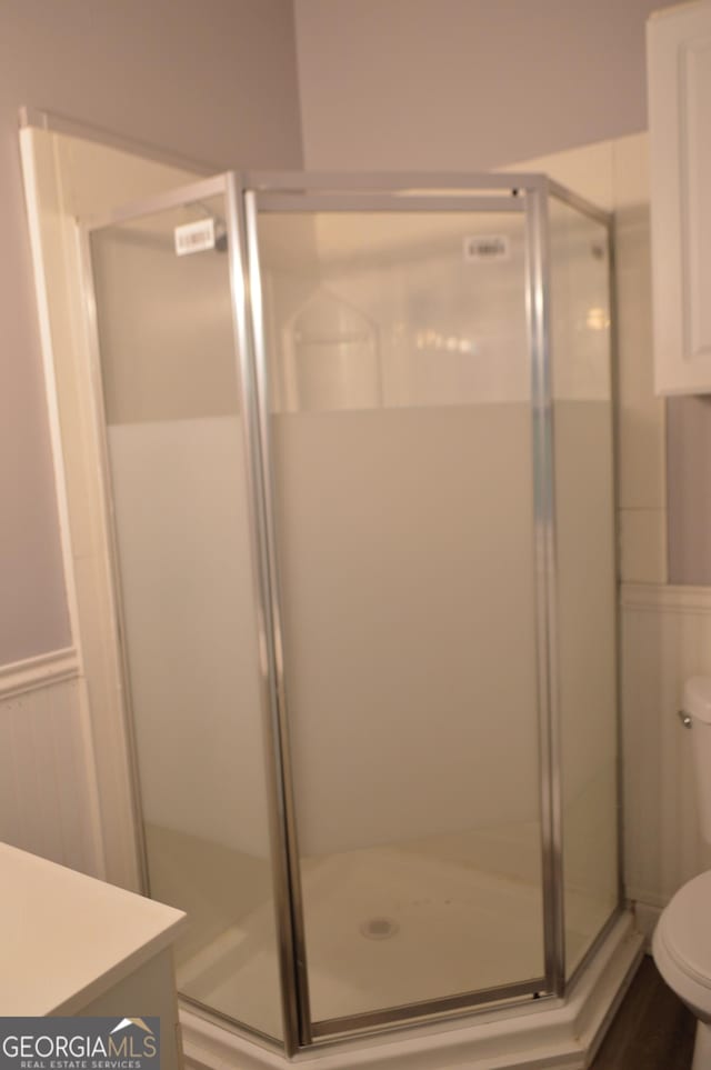 66 Topaz Ln, Royston, GA 30662 - bathroom featuring toilet, a shower stall, wainscoting, and vanity