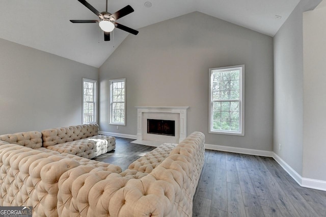 living room featuring a fireplace, baseboards, wood finished floors, and ceiling fan
