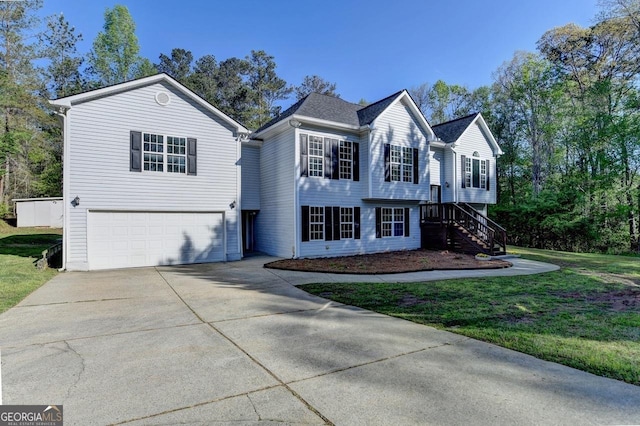 view of front of home featuring a front yard, driveway, a garage, and stairs
