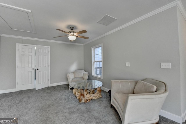 living area with visible vents, baseboards, a ceiling fan, crown molding, and attic access