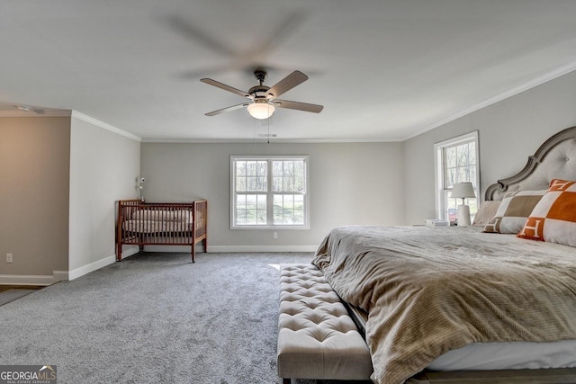 carpeted bedroom with baseboards, crown molding, and a ceiling fan